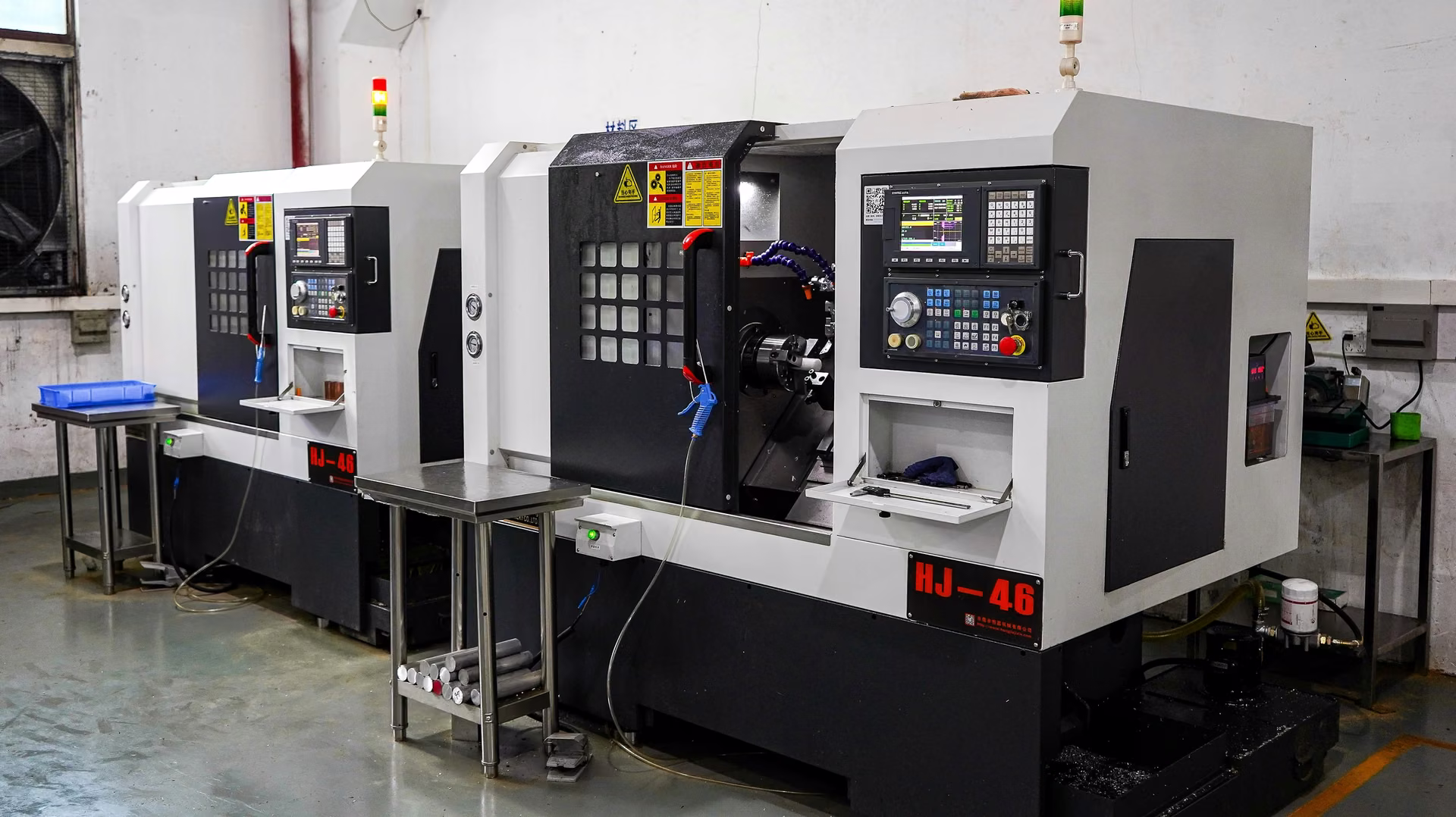 CNC turning workshop with two production lathes and organized supporting equipment