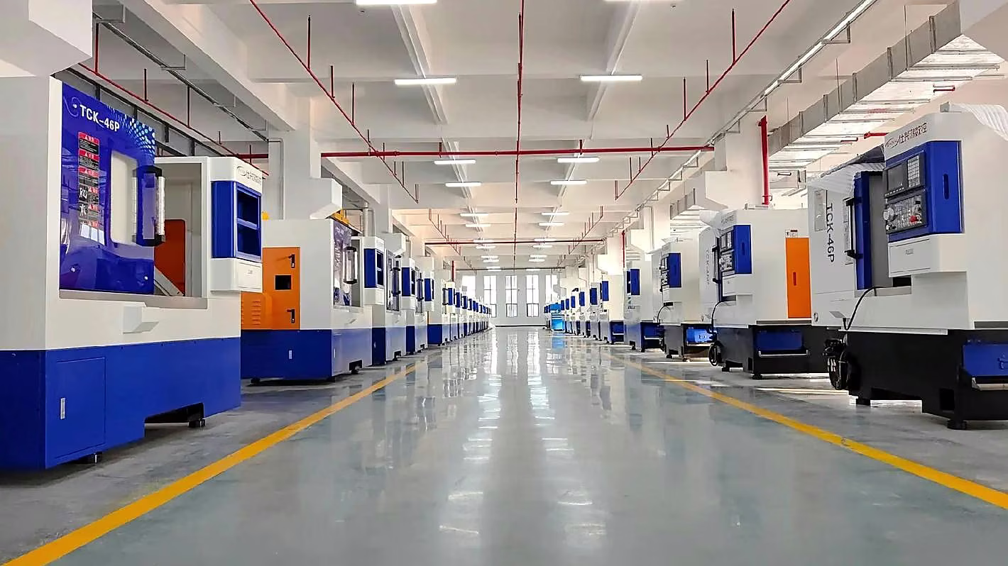 Clean manufacturing facility with an aligned row of enclosed CNC machining centers