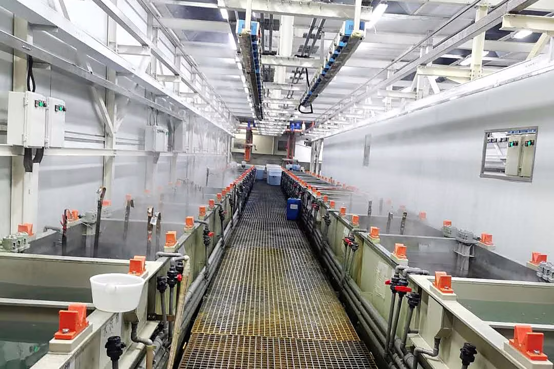Automated electroplating production line with process tanks, overhead handling equipment, and controlled work zones