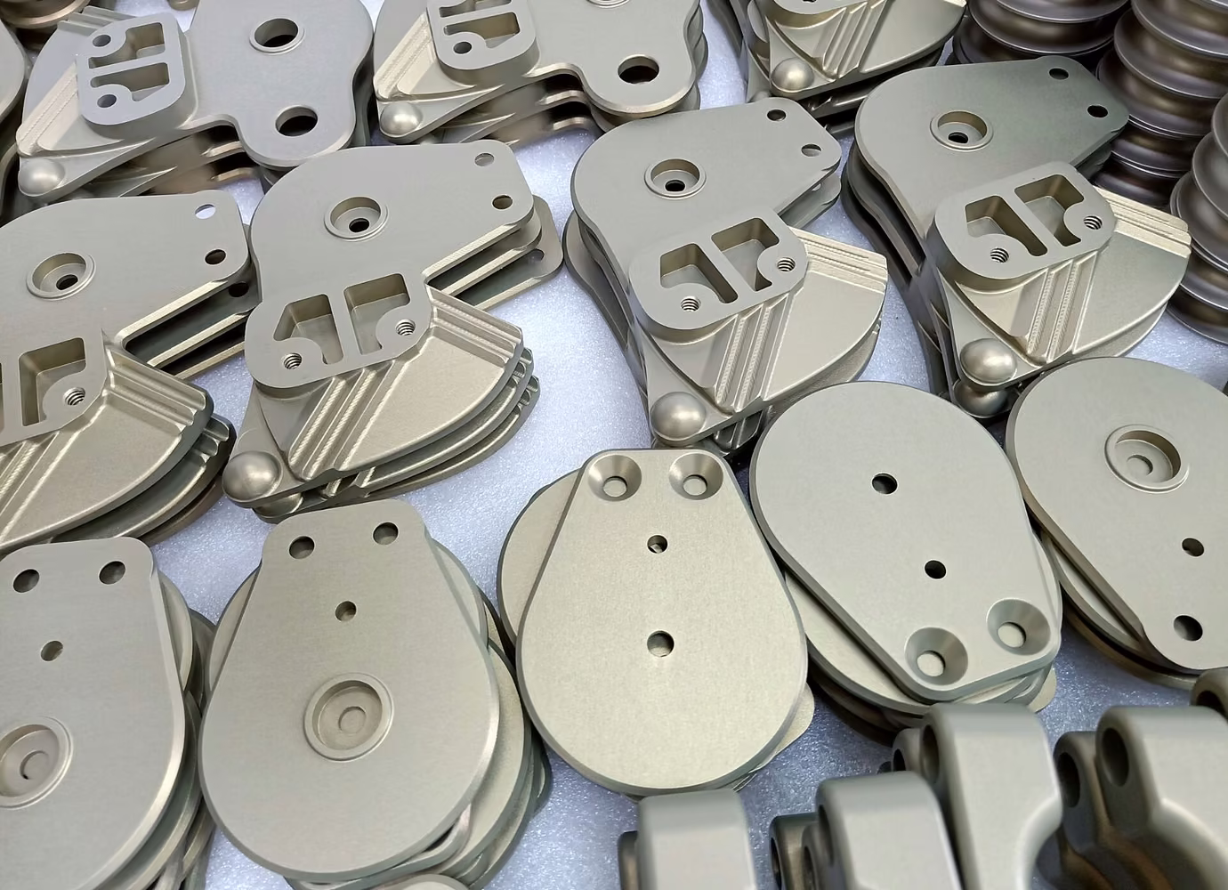 Batch of hard-anodized aluminum parts arranged for inspection and shipment