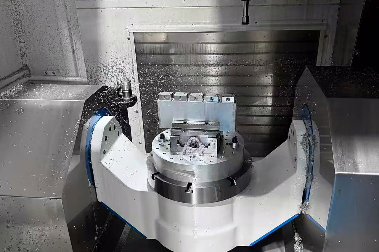 Interior of a CNC machining center with a rotary fixture prepared for production