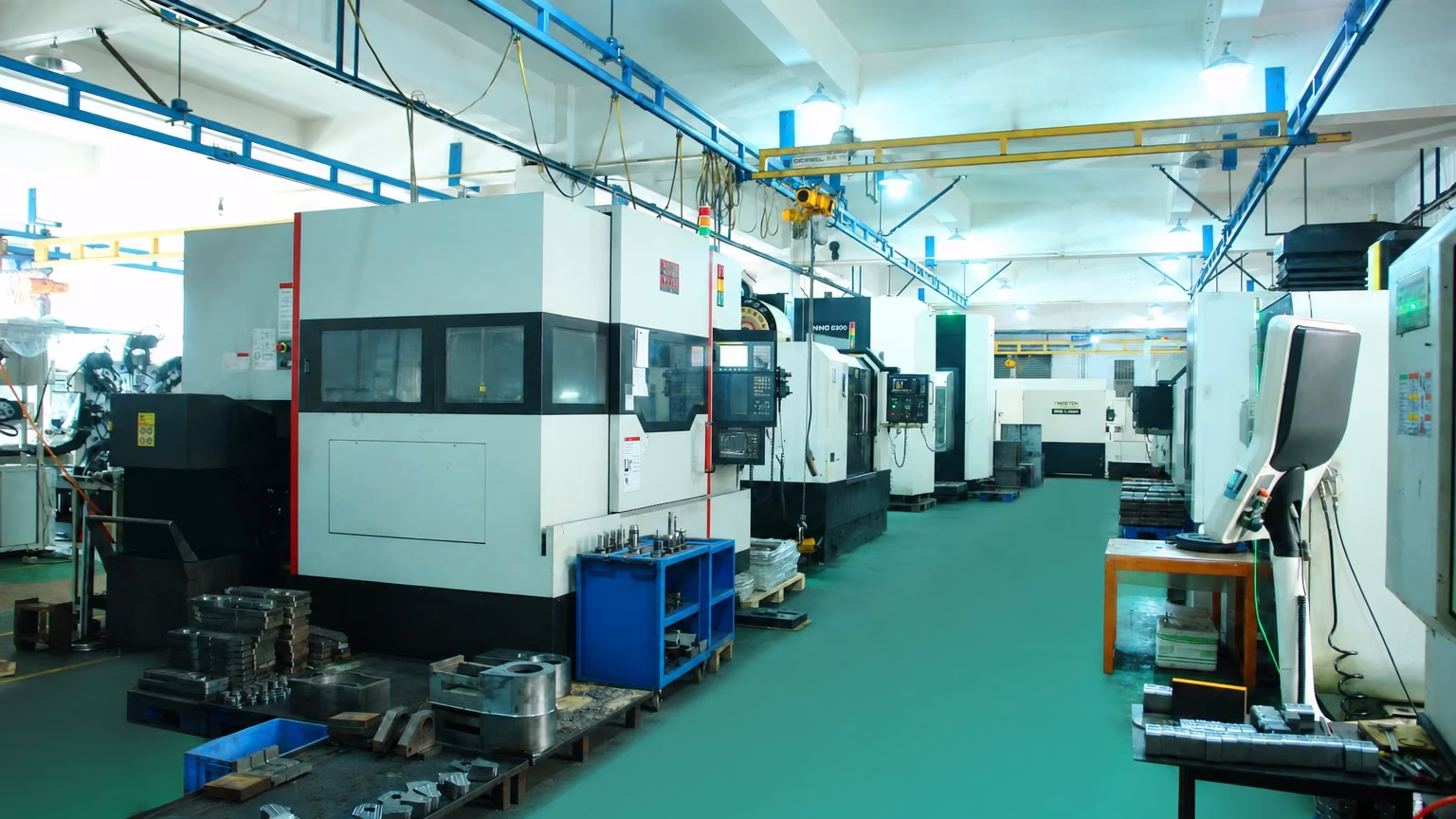 CNC production workshop with organized machine rows, tooling stations, and clear aisles