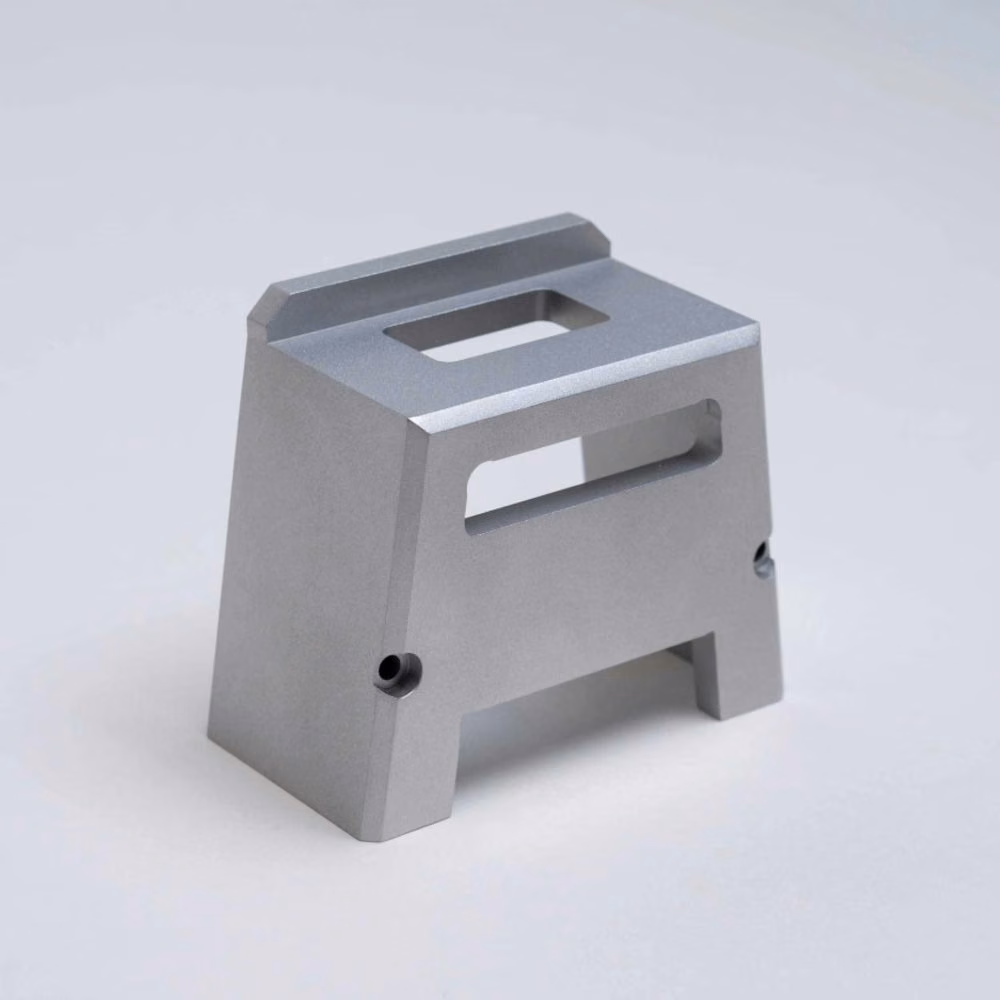 Single machined 7075 aluminum structural bracket with two rectangular openings and finished mounting faces.