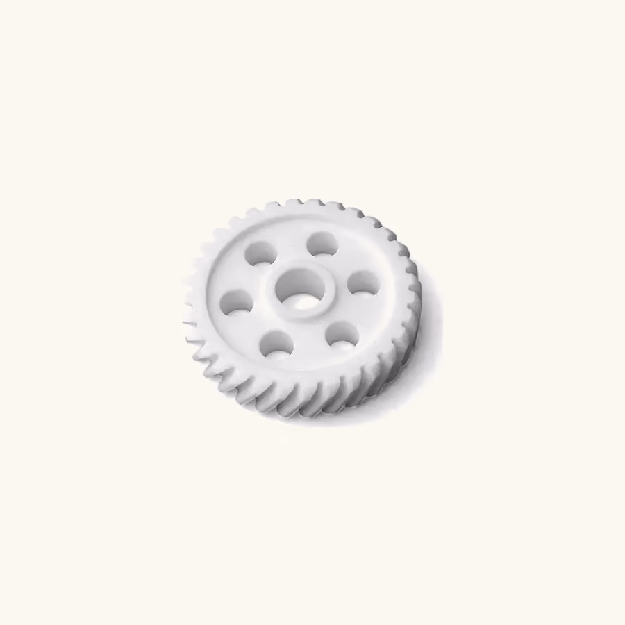 Single white machined POM helical gear with a central bore and lightening holes on a warm neutral background.