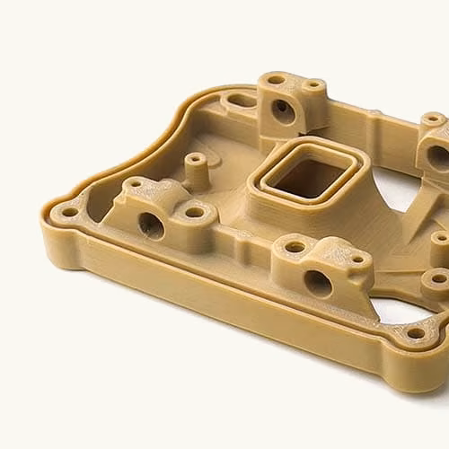 Natural tan machined PEEK fixture with pockets, bosses, holes, and clean finished edges.