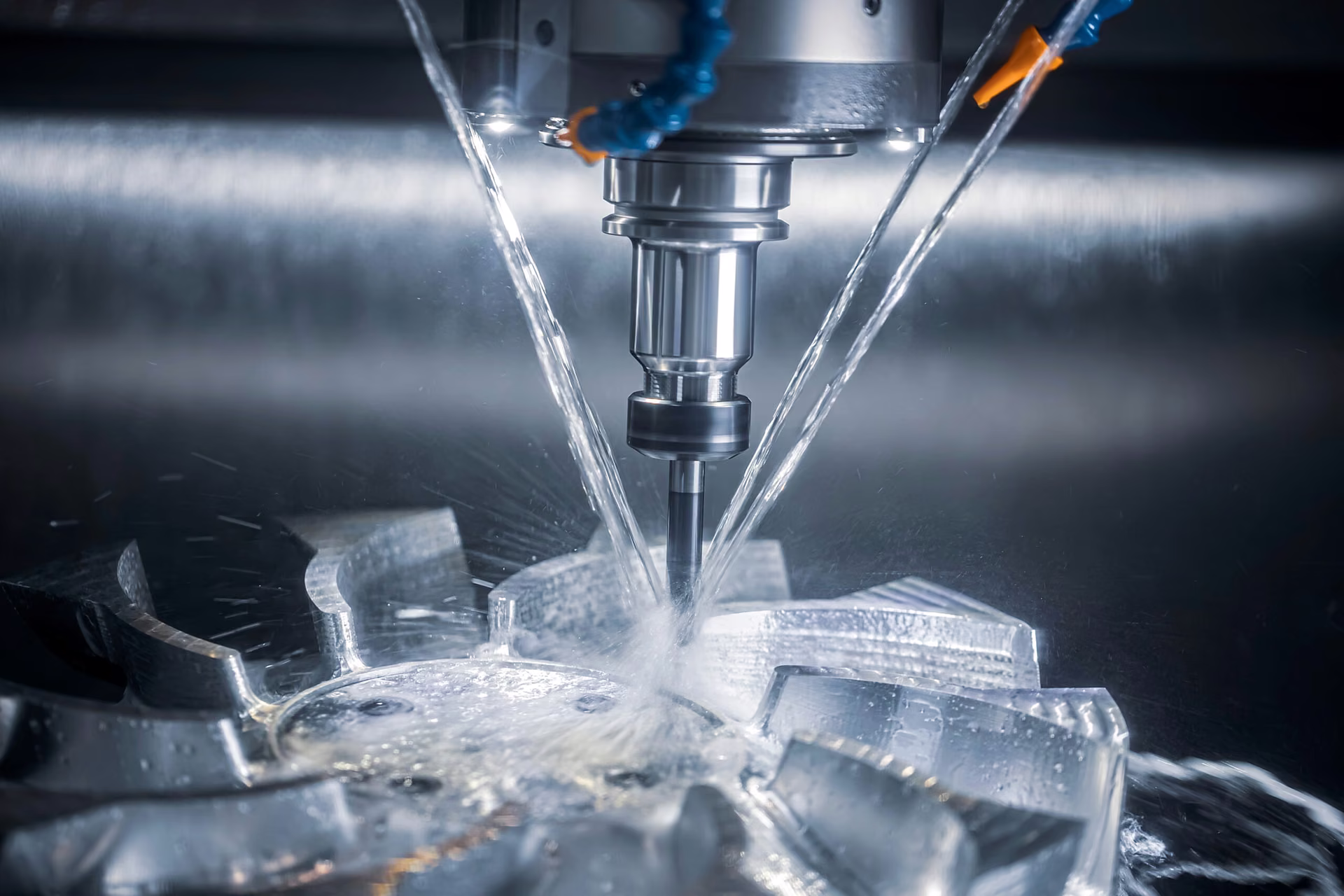 CNC milling spindle cutting an aluminum workpiece under directed coolant jets