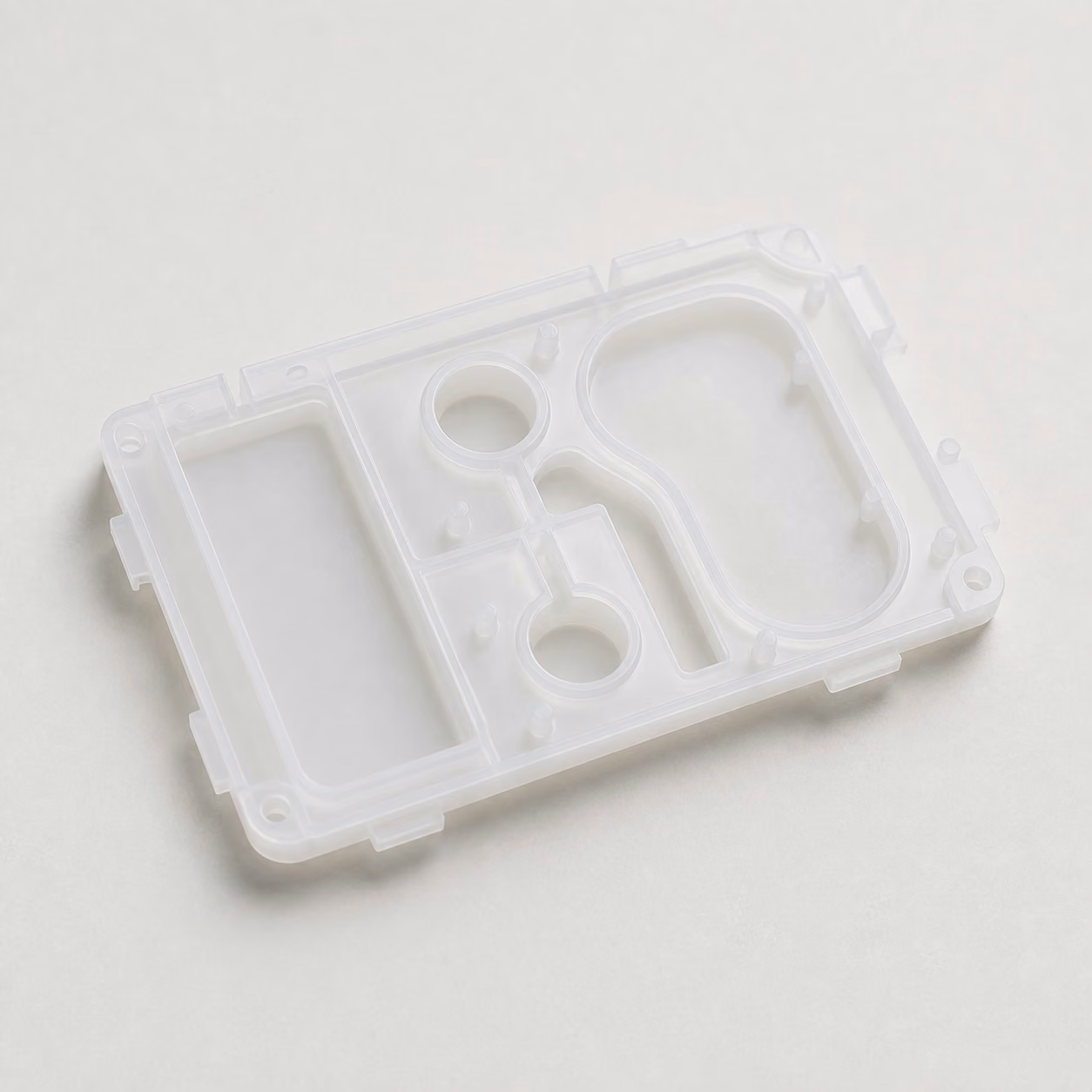 Medical-grade polypropylene diagnostic cartridge housing with molded fluid chambers, locating features, snap interfaces, and defined sealing boundaries.