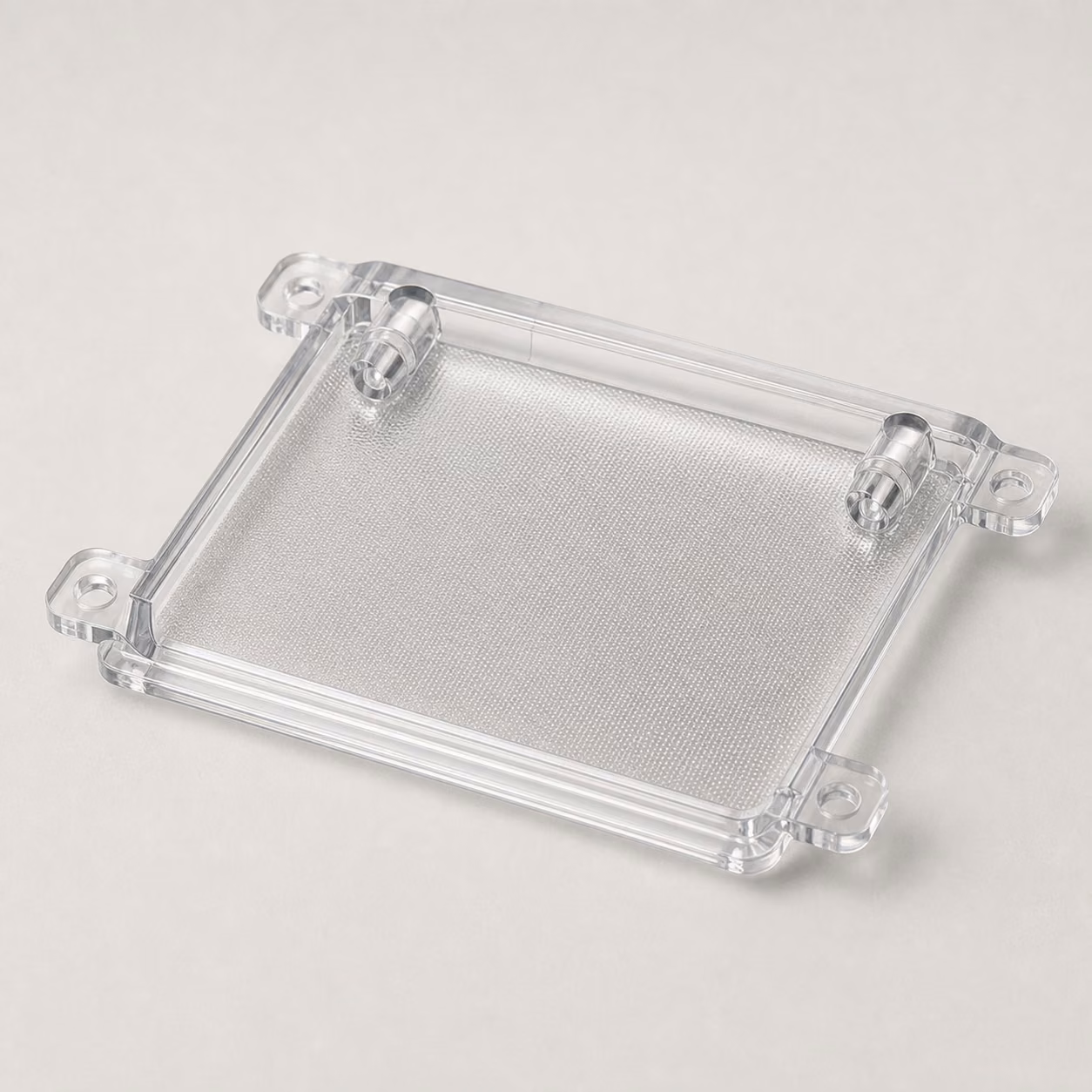 Clear injection-molded polycarbonate light guide with polished optical surfaces, light-entry features, mounting tabs, and edge details.