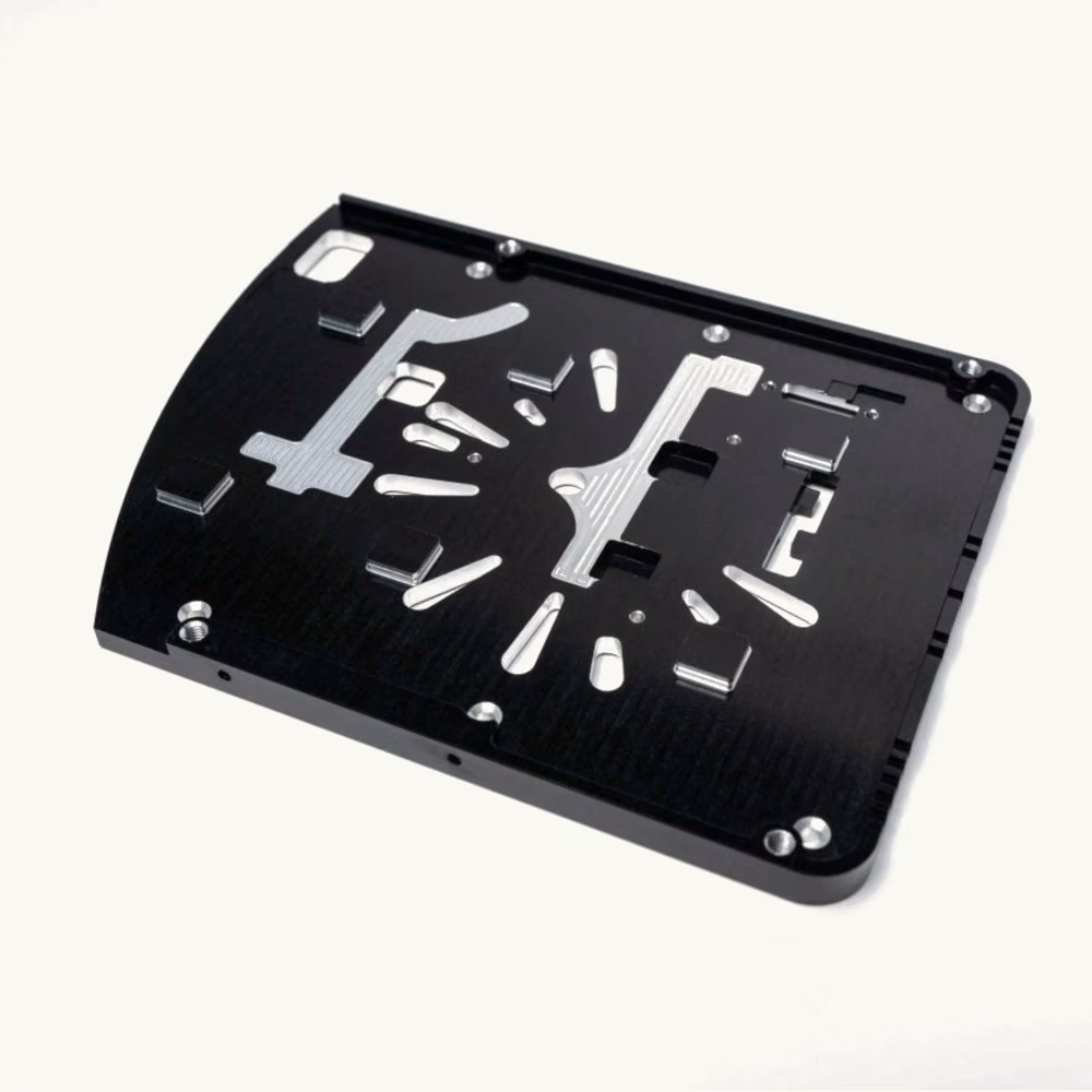 Black anodized aluminum equipment faceplate with multiple precision-cut openings and corner mounting holes.