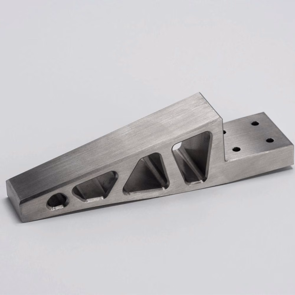 Brushed stainless steel equipment bracket with large lightening openings, through-holes, and a stepped mounting interface.