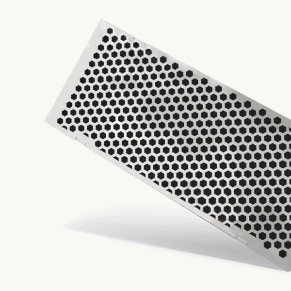 Formed sheet metal electronics cover with a dense circular ventilation pattern and clean bent edges.