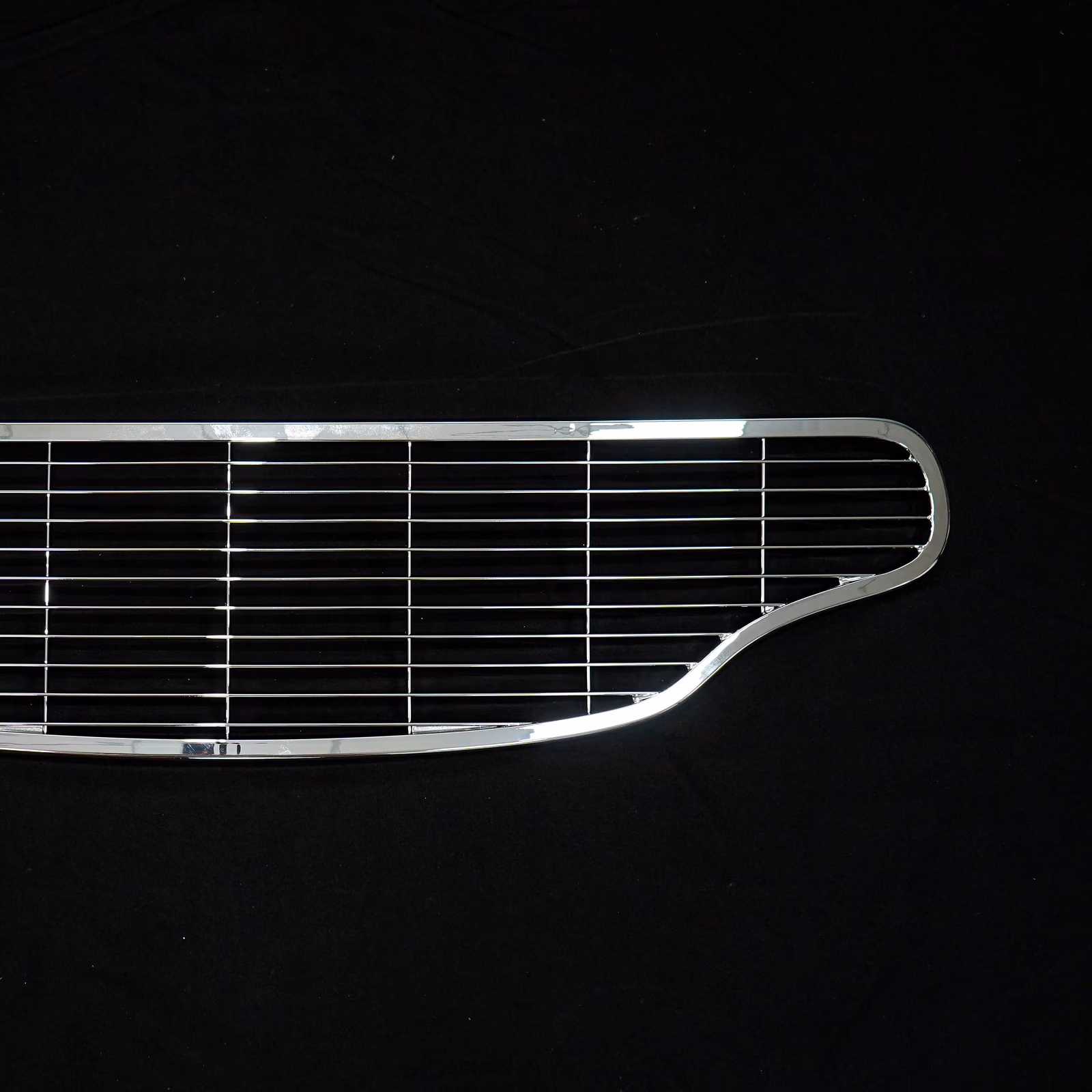 Black fabricated steel wire grille with a rounded perimeter and evenly spaced horizontal bars.
