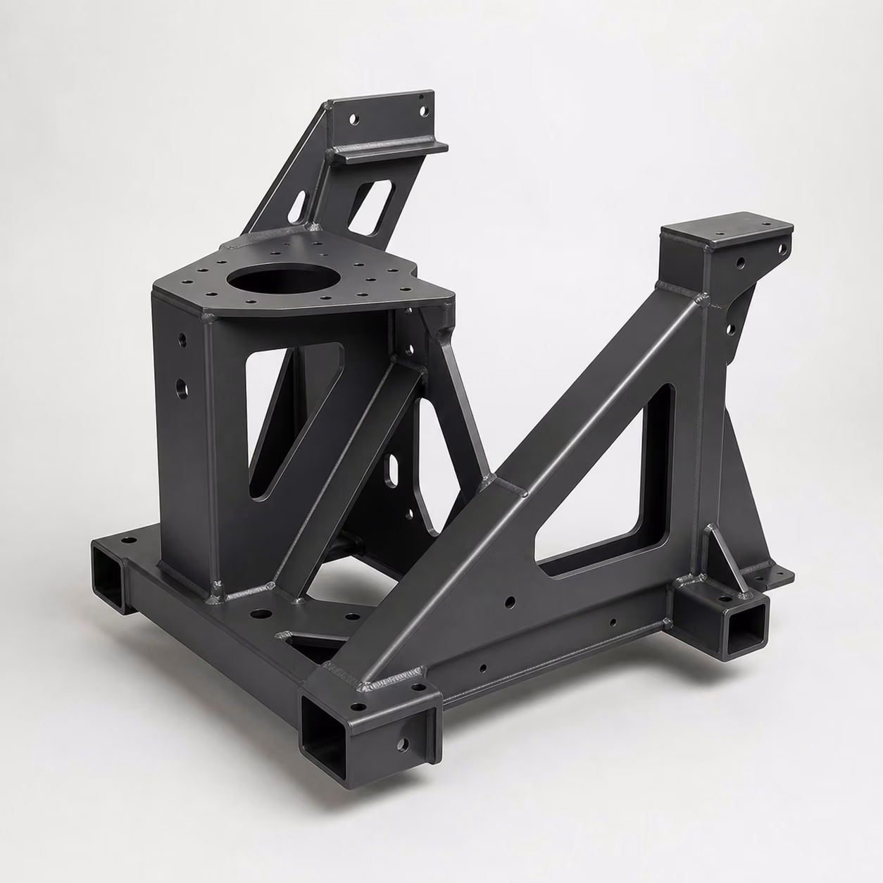 Black welded carbon steel machine base assembly with structural tubing, formed plate, reinforcing gussets, and mounting interfaces.